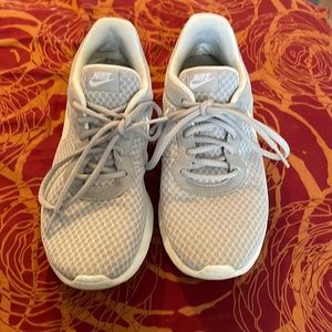 Gray and white Nikes .